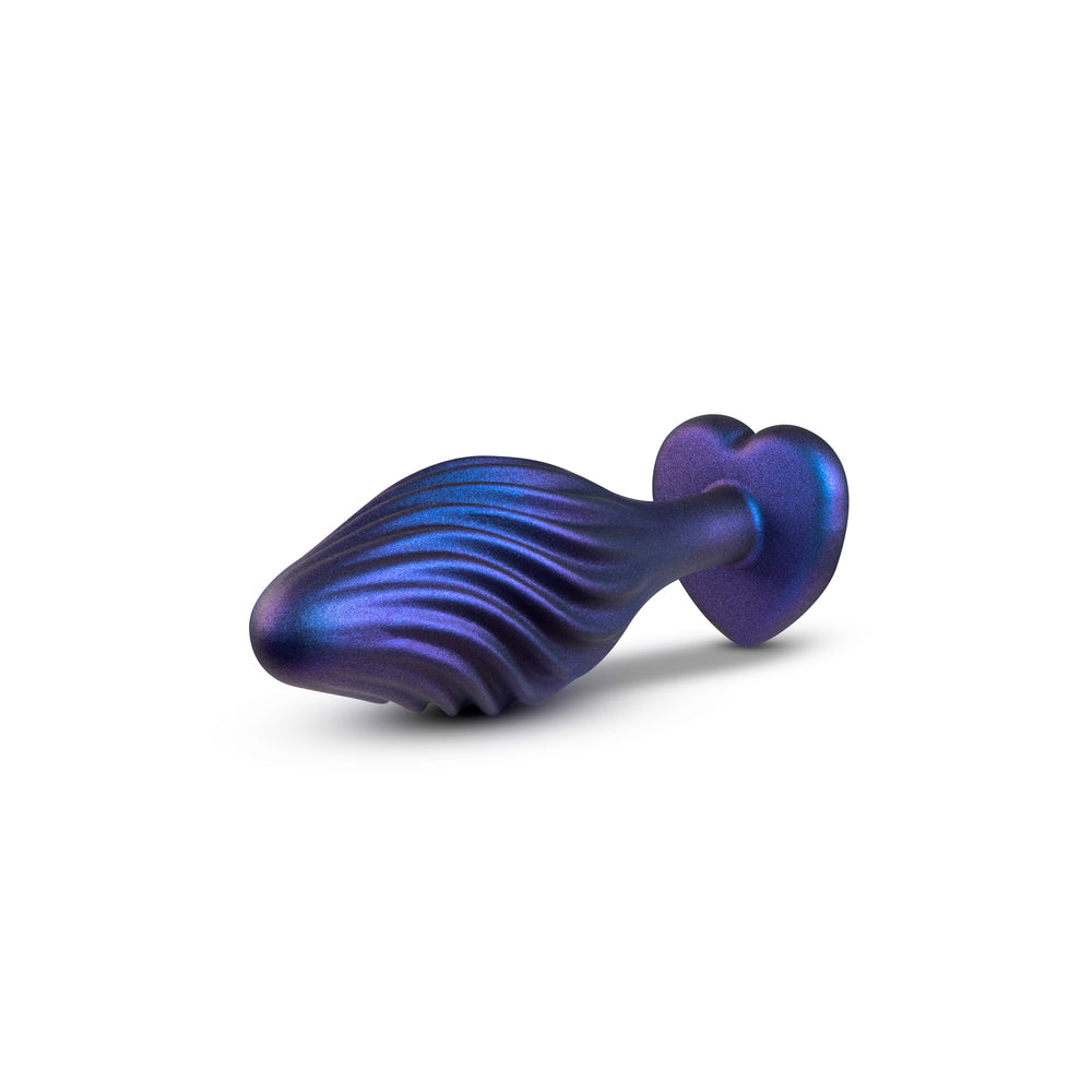 A swirling matrix butt plug from blush novelties, glittering with bling for anal play.