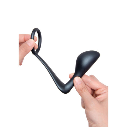 Close-up on a sleek, silver-toned b-vibe ringer cock ring with attached plug; love ring