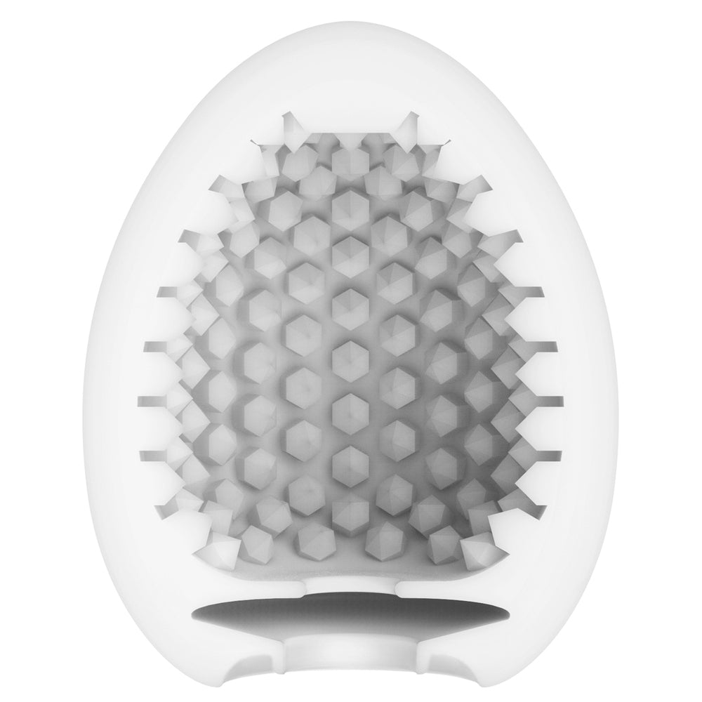 Tenga stud egg masturbator, textured white design, for solo pleasure and intimate experiences.