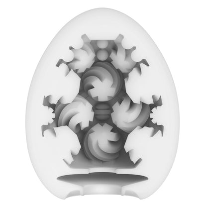Tenga curl egg masturbator, textured white interior with a flexible, patterned outer shell.