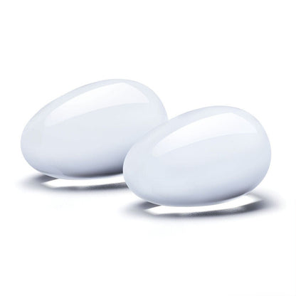 Two clear glass yoni eggs, part of an orgasm balls set from Various Toy Brands.