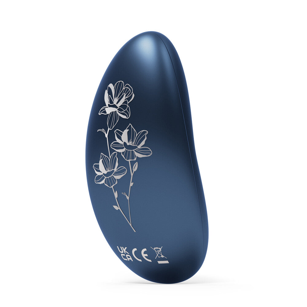 Close-up of a petite alien-shaped vibrator in a smooth, skin-safe material for clitoral stimulation.