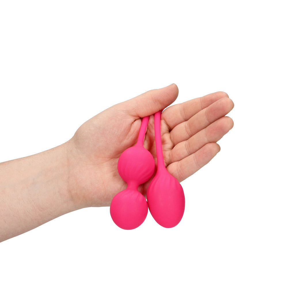 A set of three pink, weighted kegel exercise balls from shots toys, for pelvic floor training.