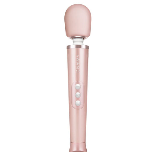 Close-up of a petite, gold-coloured Le Wand rechargeable wand massager; smooth finish and compact design.