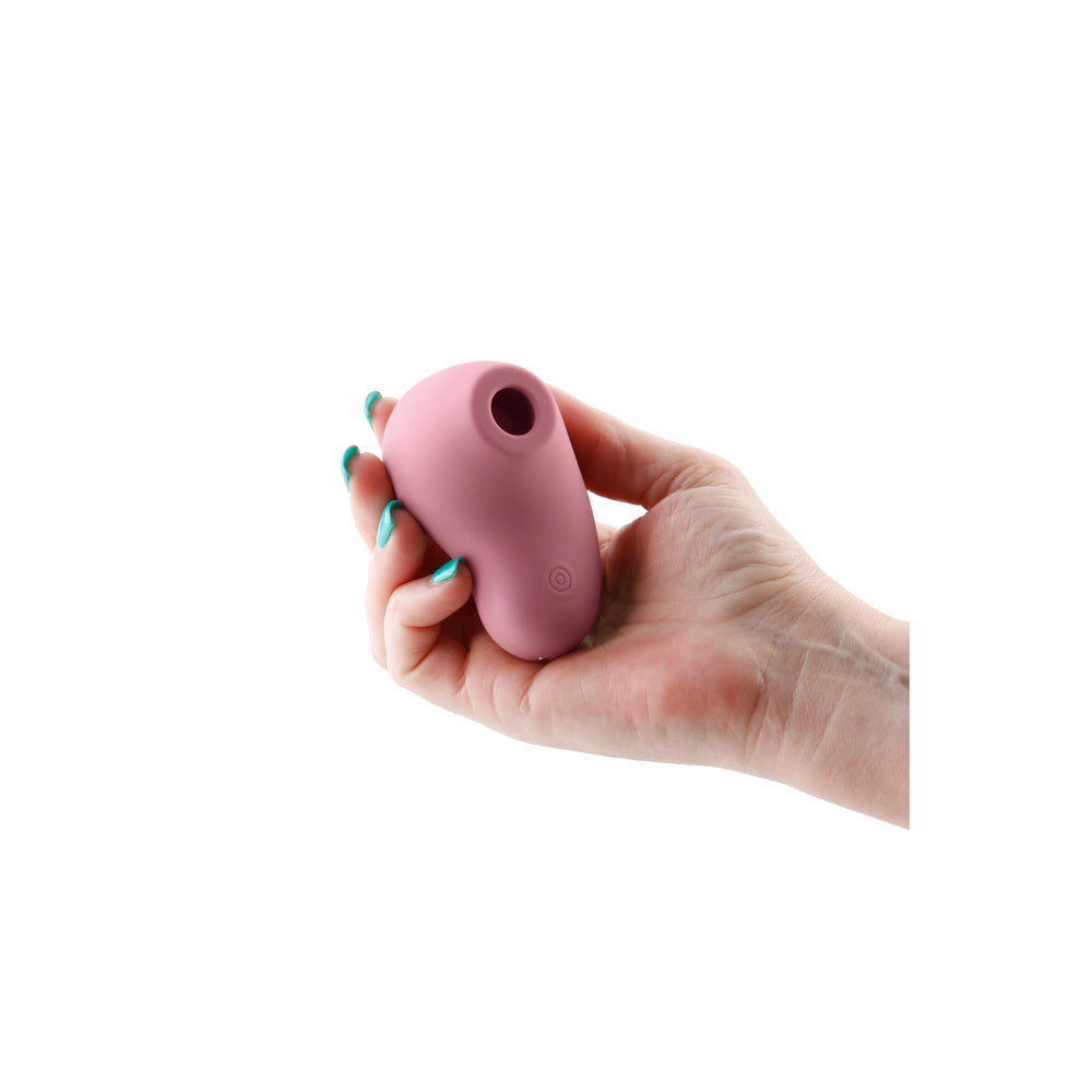 Close-up of a sleek, rose gold clitoral vibrator from NS Novelties, designed for pleasure.