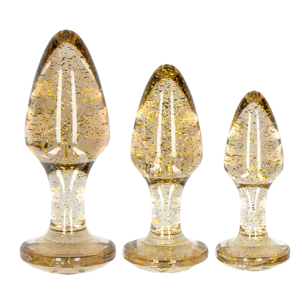 Three gold glitter acrylic butt plugs in varying sizes, a sparkly anal pleasure set.