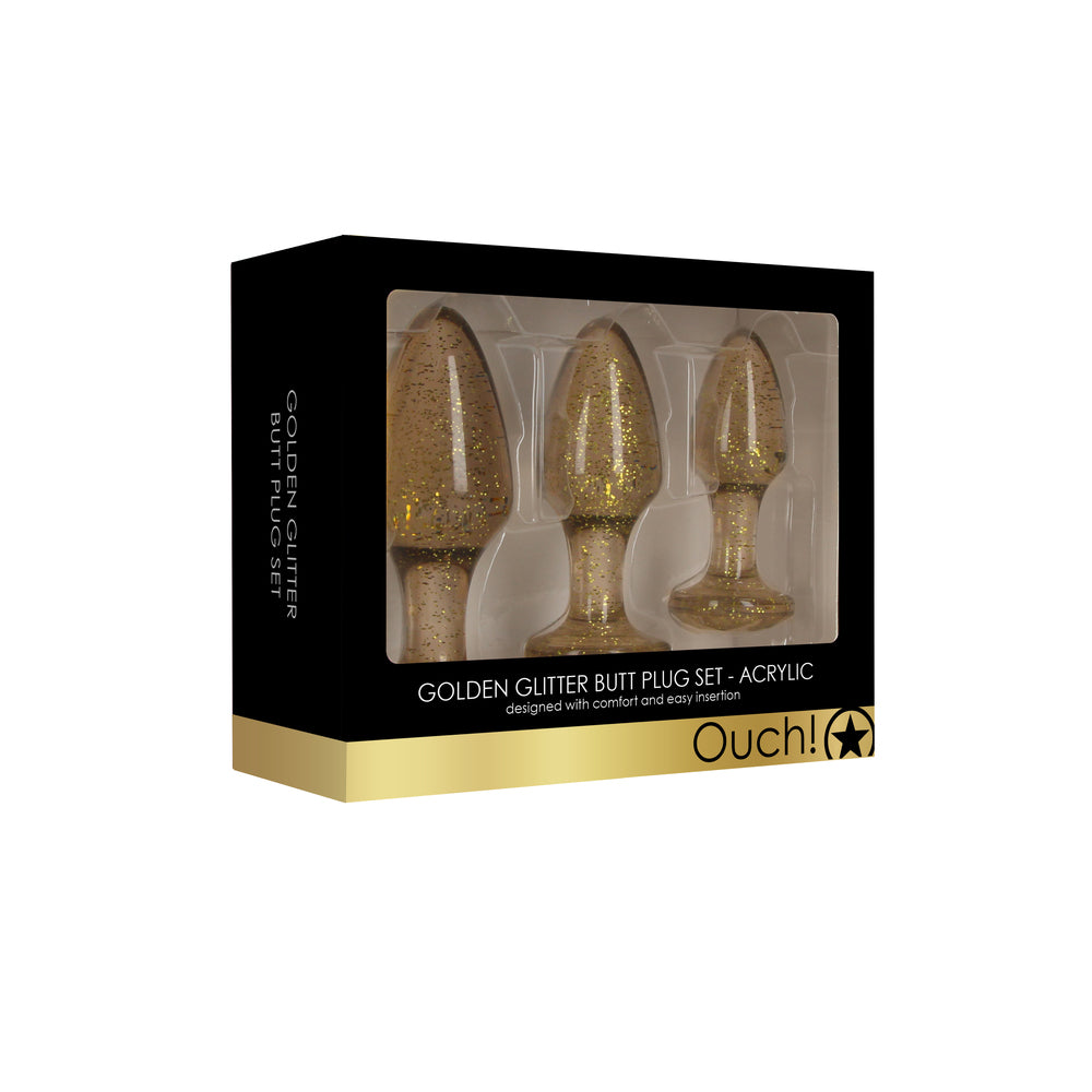 Set of three golden glitter acrylic butt plugs from Shots Toys, different sizes.
