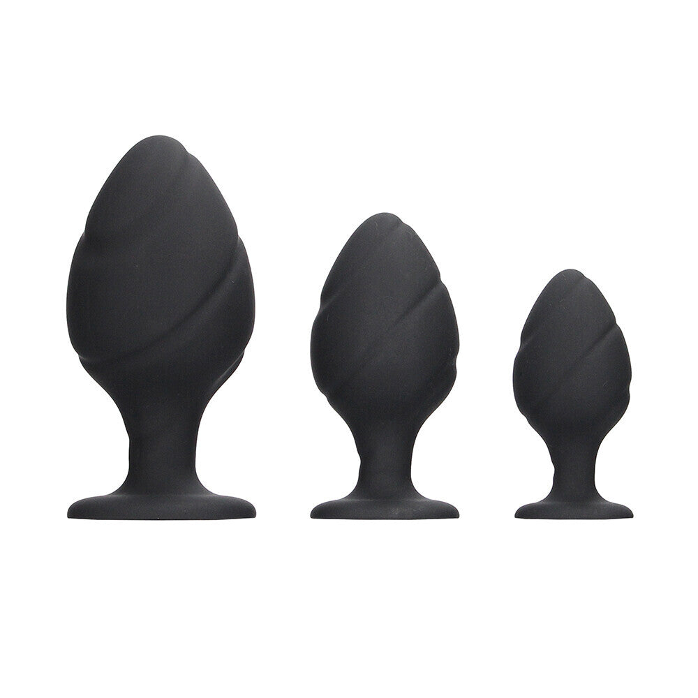 Black silicone butt plug set with a swirled design, perfect for anal play.