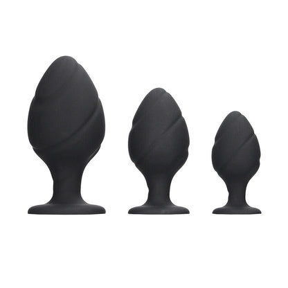Black silicone butt plug set with a swirled design, perfect for anal play.