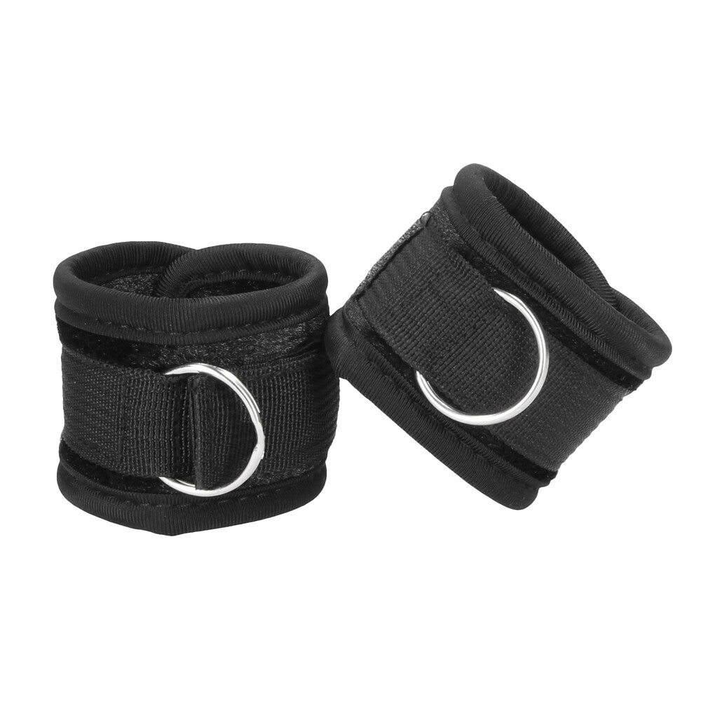 Shots Toys ouch velvet and velcro wrist cuffs in black, a kinky bedroom accessory.