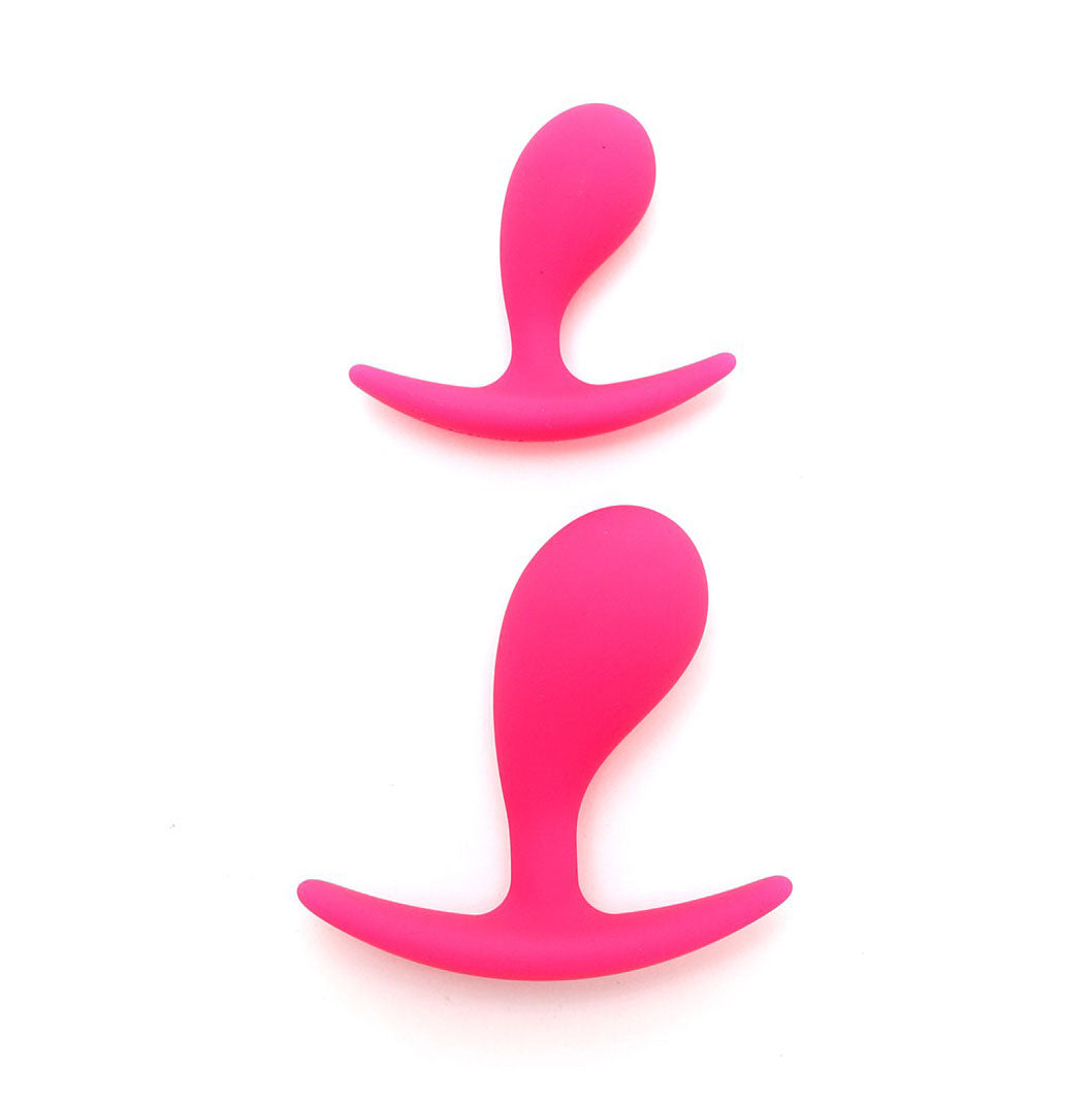 Two pink, smooth silicone anal plugs from Rimba, one larger, for intimate pleasure.