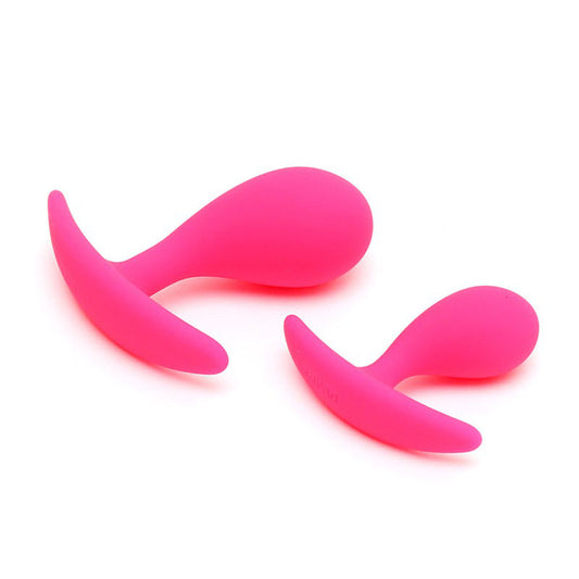 Two pink, smooth silicone butt plugs from rimba, a graduated set for anal play.