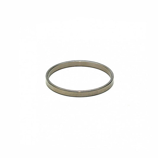 Close-up of a smooth, solid stainless steel cockring, 0.5cm wide and 30mm diameter.