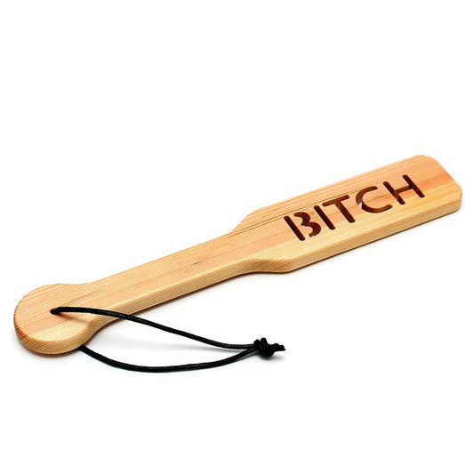 rimba wooden paddle, handcrafted from natural timber, with a smooth, ergonomic handle for playful spanking.
