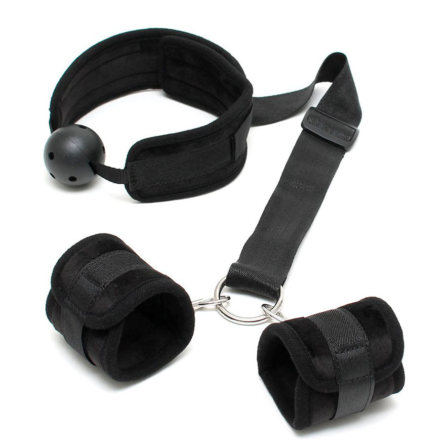 Rimba breathable mouth gag with wrist cuffs from a bondage kit, showing restraint.