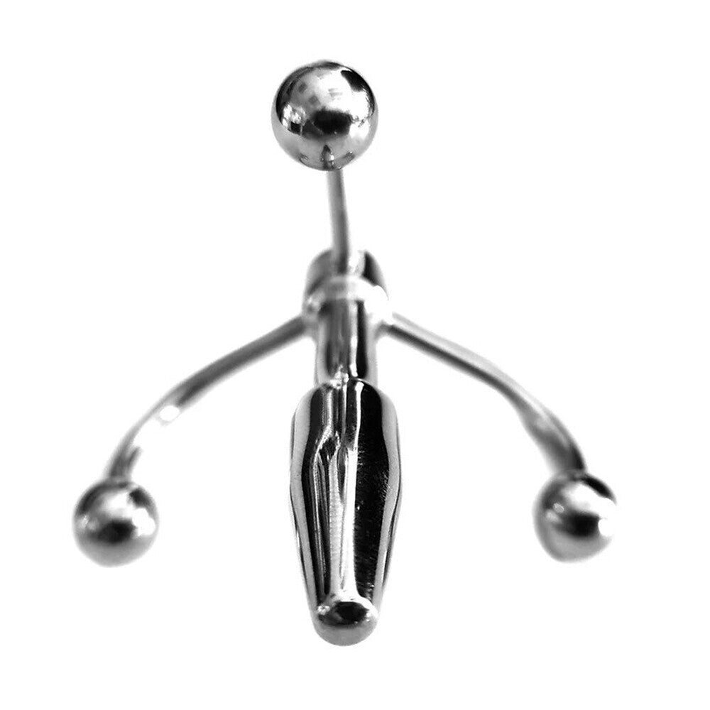 Close-up of a stainless steel crown penis plug, a medical instrument with a polished finish.