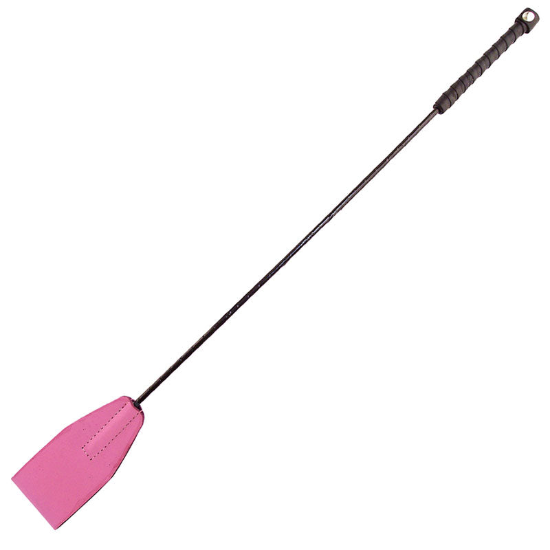 Close-up of a pink riding crop with a textured handle, for equestrian use.