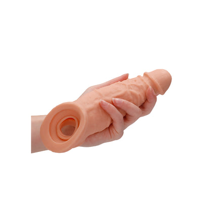 Flesh pink, nine-inch penis sleeve by shots toys, made of flexible, realistic material.