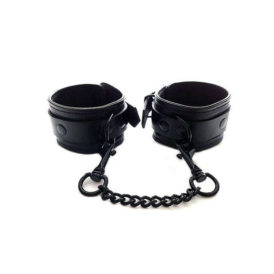 Plain black ankle cuffs, possibly nylon, designed as restraints. A simple, dark accessory.