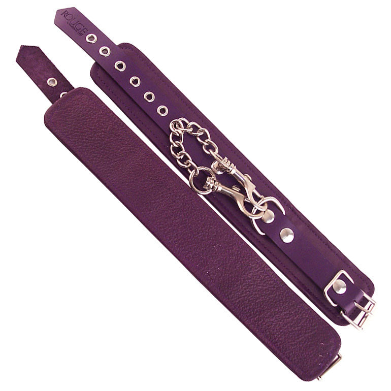 Rouge Garments purple ankle cuffs, used as restraints, with a shiny, smooth finish.