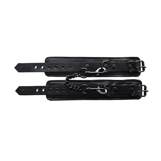 Plain black wrist cuffs by rouge garments, looking rather kinky and bondage-inspired.