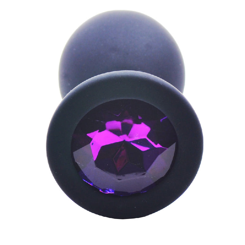 Small black silicone butt plug with a faceted jewel at the base, smooth finish.