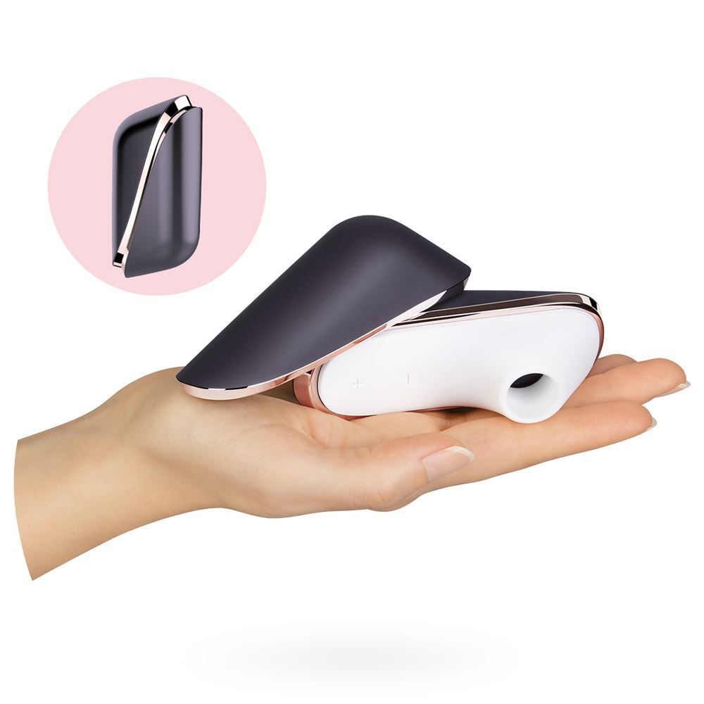 Close-up of a purple satisfyer pro traveller clitoral vibrator with wave design detailing, for pleasure.