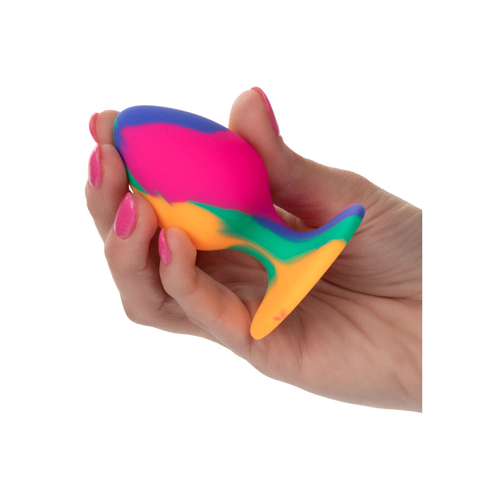 A tie dye patterned, medium-sized butt plug from california exotic, for cheeky anal fun.