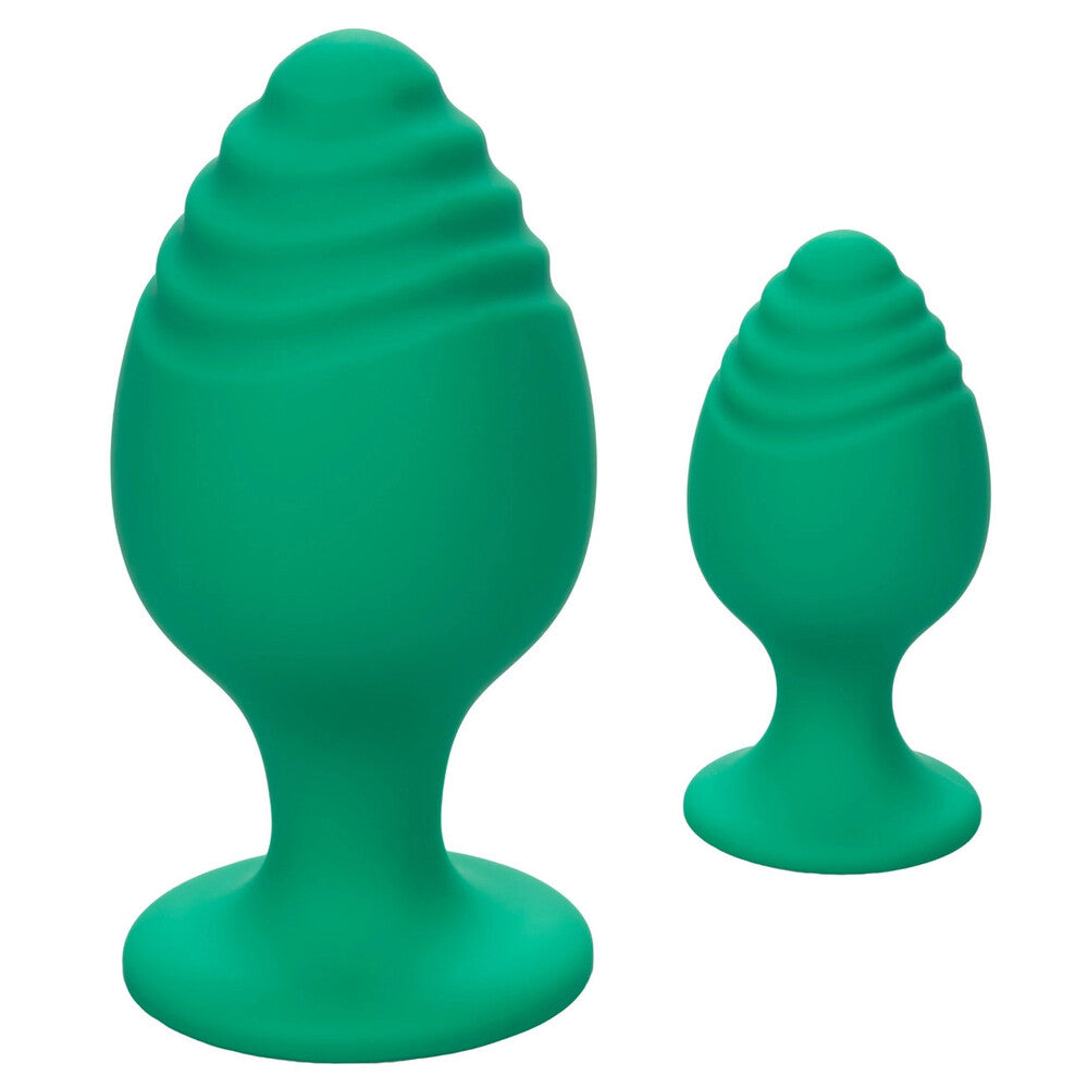 A pair of cheeky green butt plugs from California Exotic, smooth and playfully shaped.
