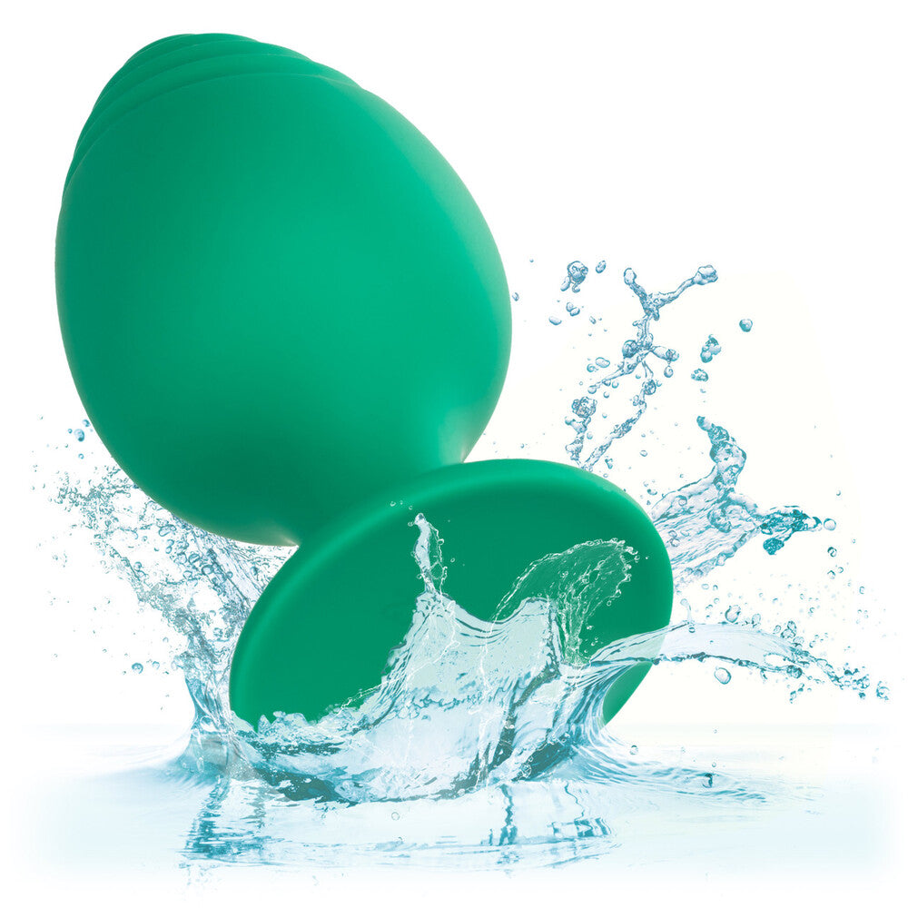 A pair of green silicone butt plugs from California Exotic, smooth finish.