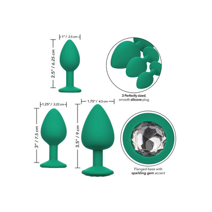 A set of three green cheeky gems butt plugs from california exotic, graduated sizes.