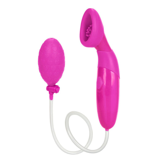 Close-up of a pink, waterproof silicone clitoral pump from California Exotic, used for female pleasure.