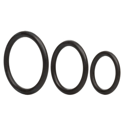 Close-up of a three-pack of black, textured rubber love rings, for intimate use.