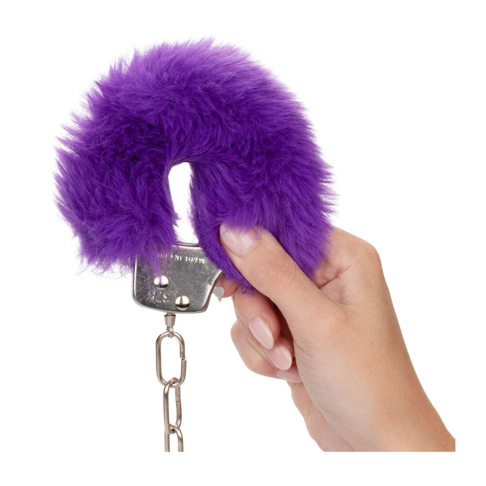 Close-up of ultra fluffy furry handcuffs in a vibrant purple colour, perfect for playful restraint.