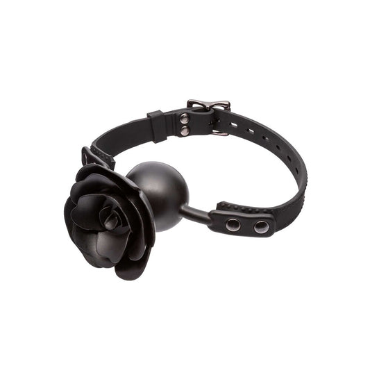 Close-up of a removable, black faux leather gag with a prominent red rose feature.