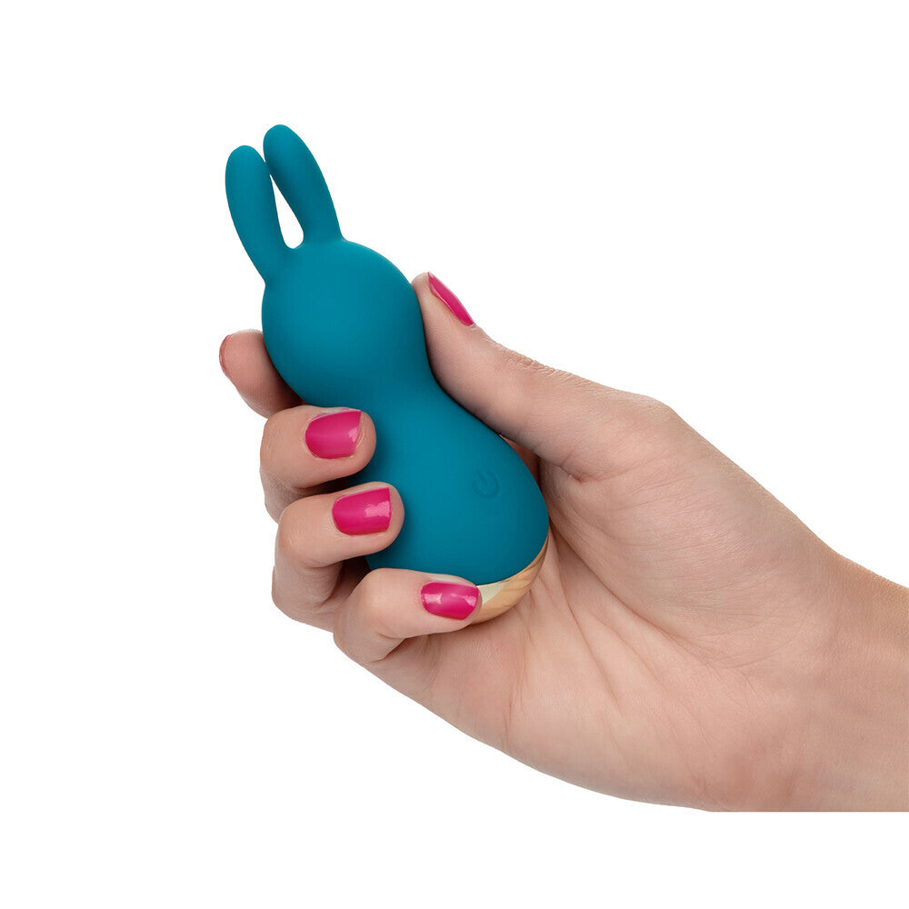 Close-up of a rose gold clitoral stimulator by california exotic, for intimate use.