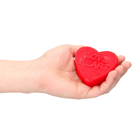 Love heart shaped soap bar, rose scented and pink, a novelty bathroom accessory.