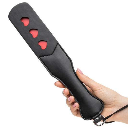 Sportsheets sex and mischief heart paddle in red, for playful spanking during bedroom games.