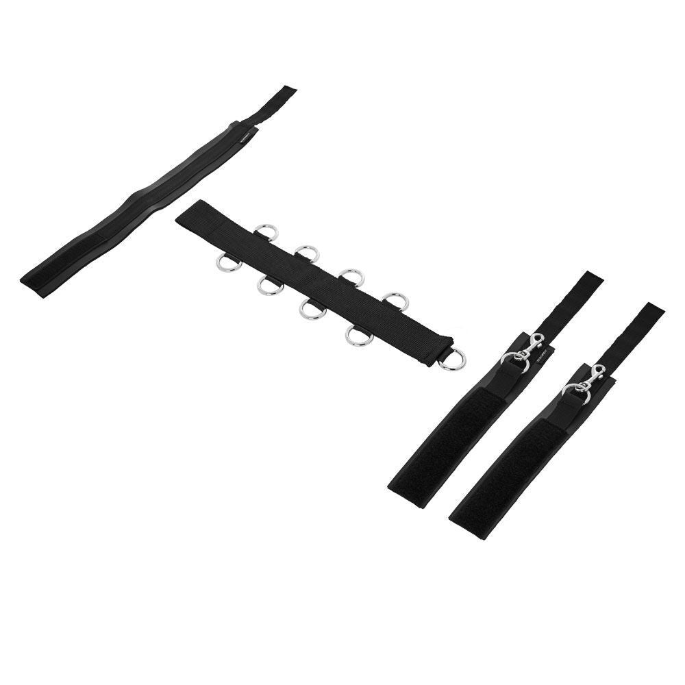 Close-up of black neck and wrist restraints for adults, crafted from soft fabric.